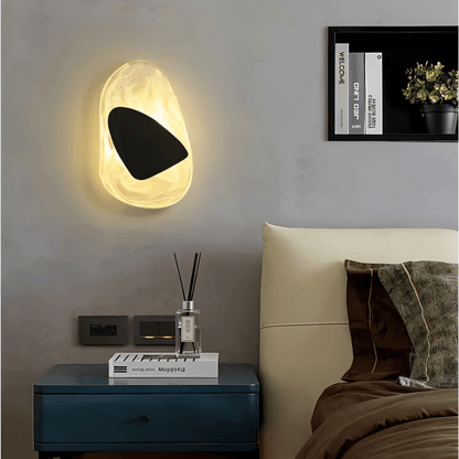 Residence Supply Petra Wall Lamp showing a sleek, modern design with a curved metal arm and a white lampshade mounted on a wall.