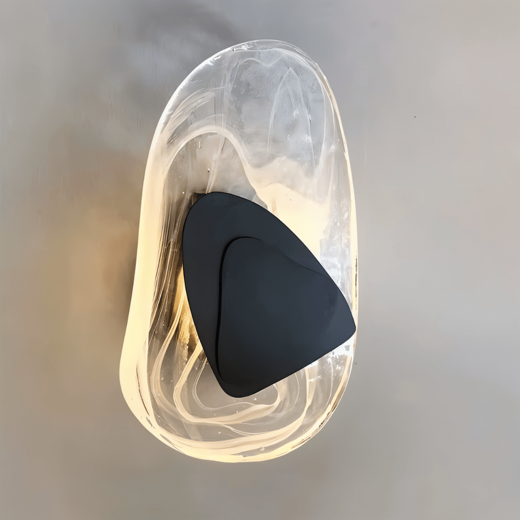 Residence Supply Petra Wall Lamp with sleek metal finish and modern design, mounted on a wall with warm lighting.