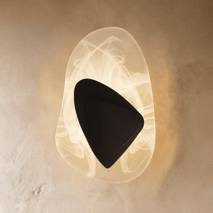 Residence Supply Petra Wall Lamp with sleek modern design and metallic finish, mounted on a white wall.