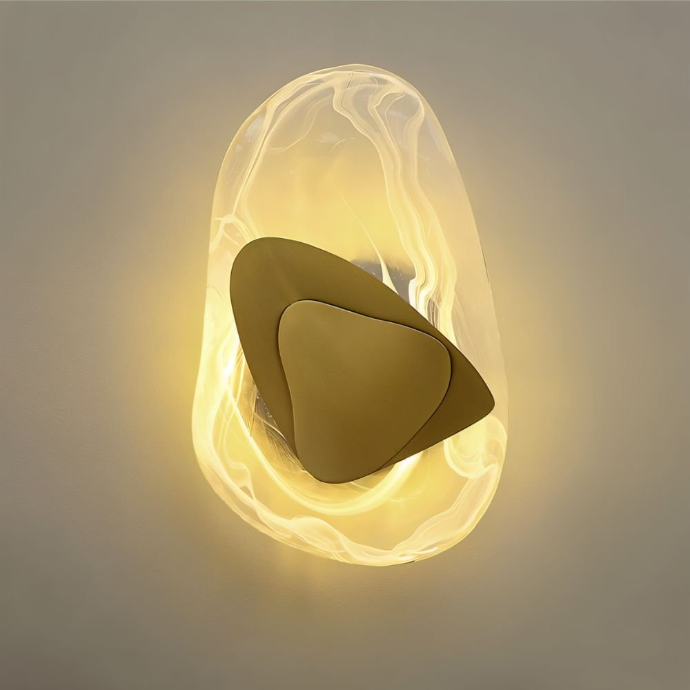 Residence Supply Petra Wall Lamp with sleek modern design, mounted on a wall with a warm light illuminating the space.