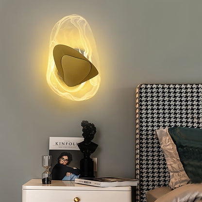 Residence Supply Petra Wall Lamp mounted on a wall with a modern design and sleek metal finish, providing stylish ambient lighting.