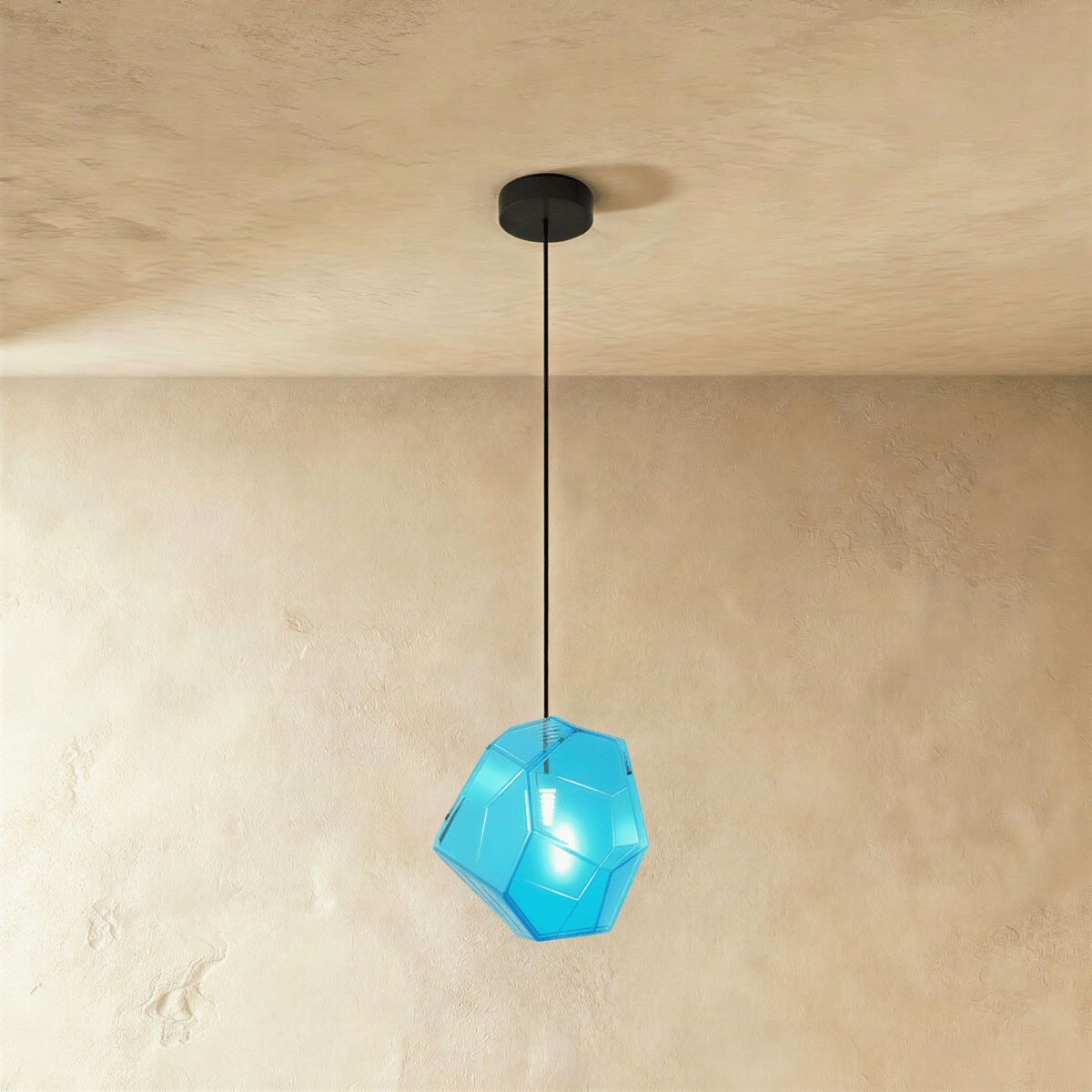 Modern Piedra Pendant Light by Residence Supply featuring a sleek stone-inspired design hanging from a cord.