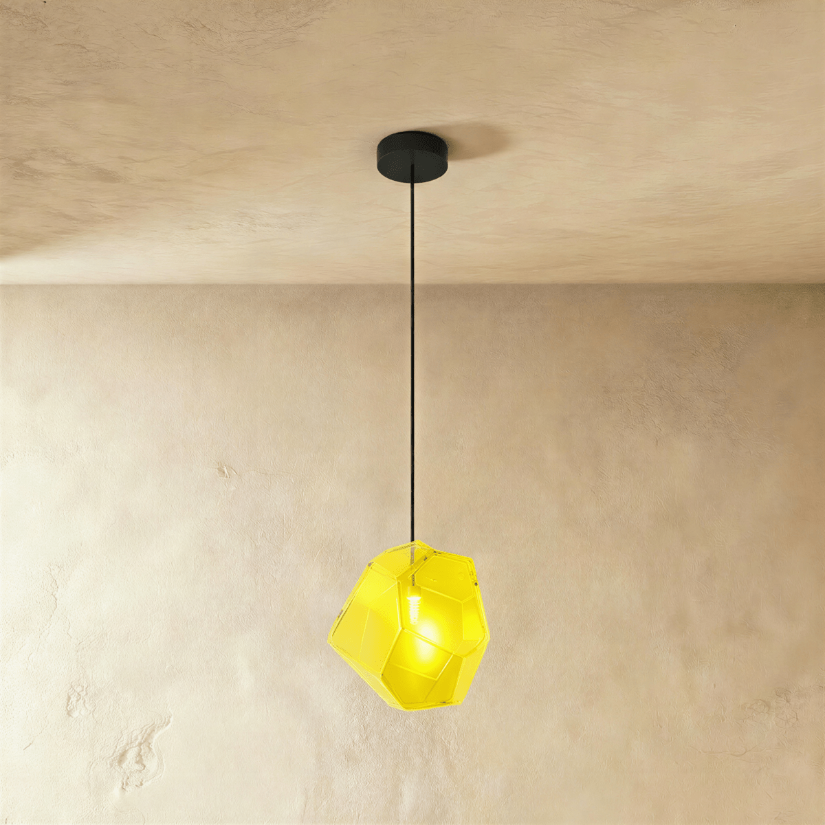 Residence Supply Piedra Pendant Light hanging with a modern design, featuring a sleek stone finish and warm ambient lighting.