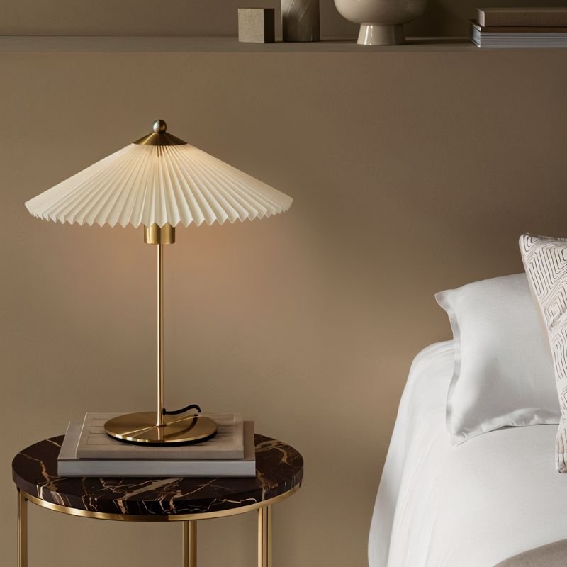 Plisse Table Lamp by Residence Supply featuring a pleated fabric shade and modern design on a wooden base.