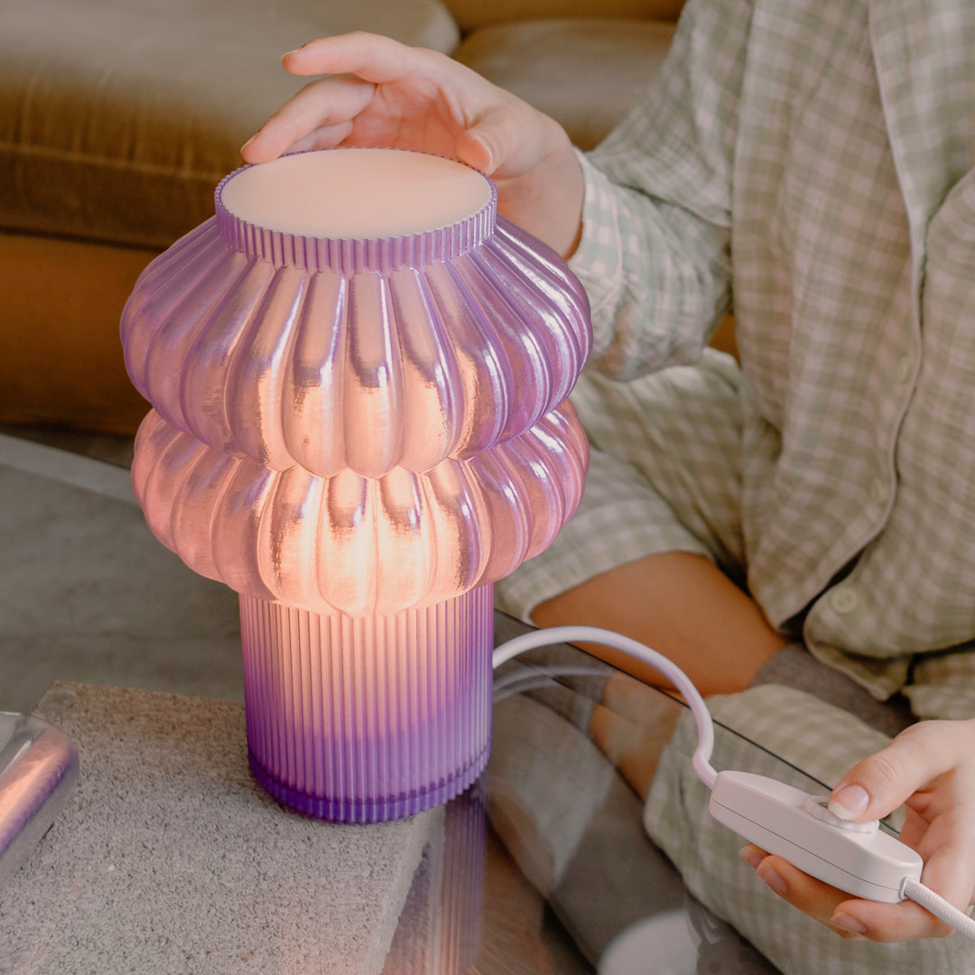 Purple Terra Labs Oppi Table Lamp with a modern, rounded design on a wooden surface, showcasing contemporary home lighting.