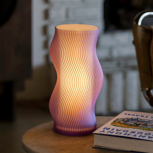 Purple Terra Labs Woogie Table Lamp with a modern, playful design, placed on a wooden surface.
