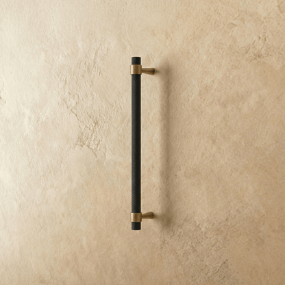 Qaris Pull Bar from Residence Supply, a sleek metal cabinet knob for home and garden furniture, mounted on a cabinet door.