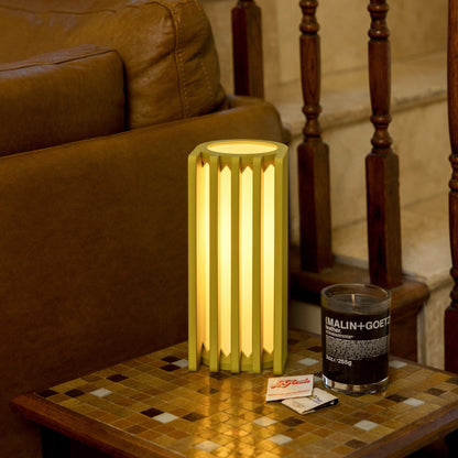 Terra Labs radiator-inspired mustard yellow table lamp on a wooden surface, modern design for living room or desk lighting.