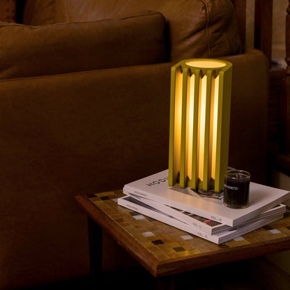 Mustard-colored Terra Labs radiator-inspired table lamp with a sleek, modern design and cylindrical shape.