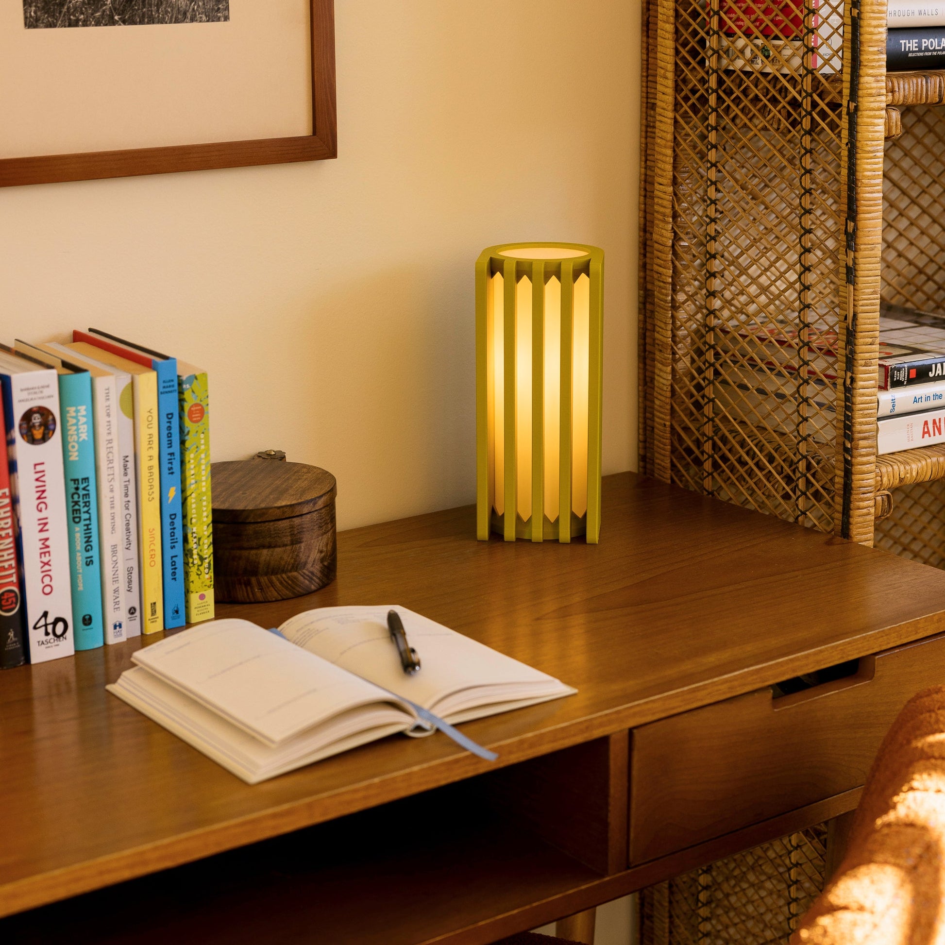 Terra Labs Radiator Table Lamp with mustard yellow finish, modern design, and cylindrical shape on a wooden surface.