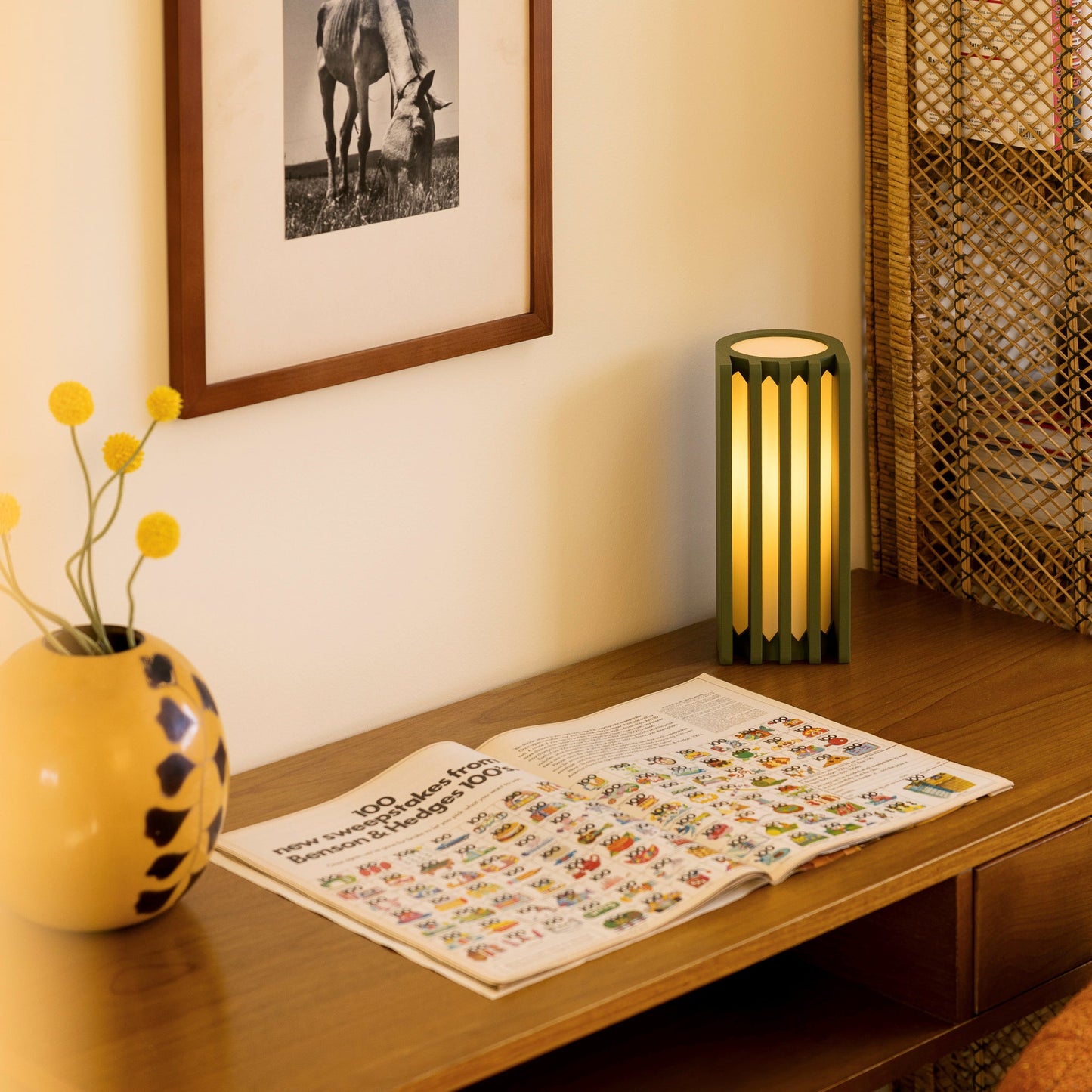 Terra Labs radiator-shaped olive green table lamp with a vintage radiator design, placed on a wooden surface.