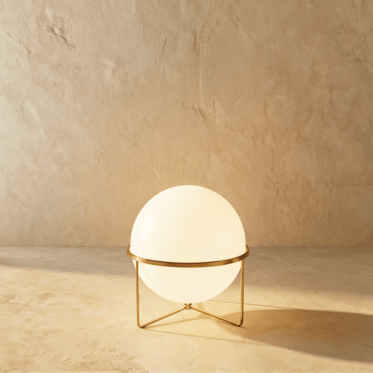 Modern Rasu Floor Lamp by Residence Supply with a sleek metal stand and fabric shade illuminating a living space.