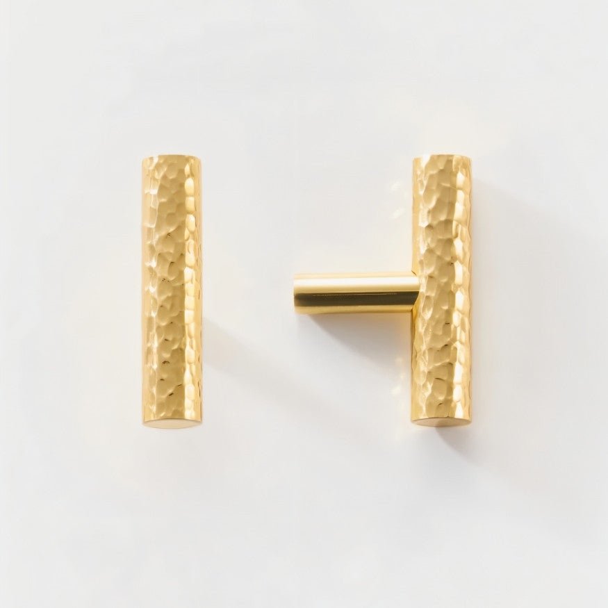 Hammered brass Remy knob and pull bar set from Residence Supply, featuring a stylish hardware design for cabinets.