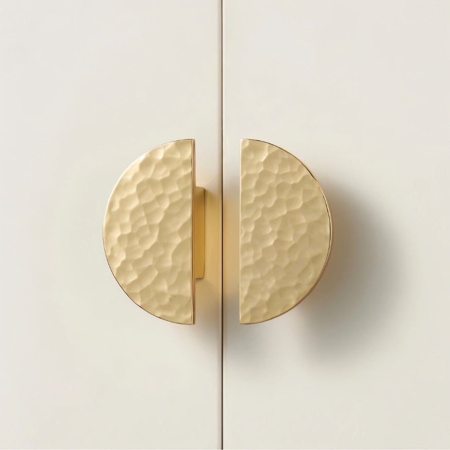 Pair of hammered brass Remy cabinet knobs with half-circle design, ideal for home and garden cabinet hardware.