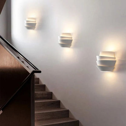 Residence Supply Rigno Wall Lamp showcasing sleek modern design with a curved metal arm and adjustable shade mounted on a wall.