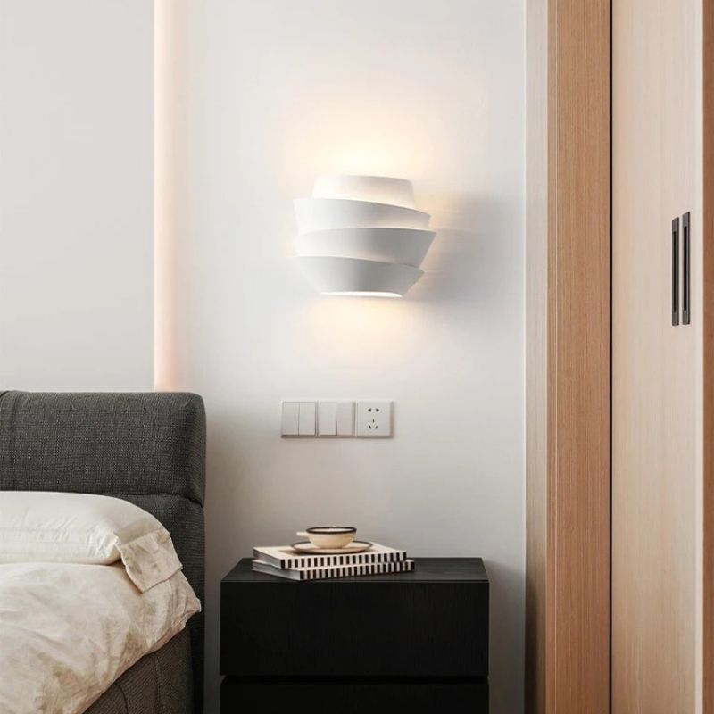 Residence Supply Rigno Wall Lamp mounted on a wall with a sleek, modern design and a black finish.