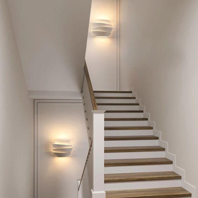 Modern Rigno Wall Lamp by Residence Supply with sleek metal finish and adjustable arm, mounted on a neutral wall.