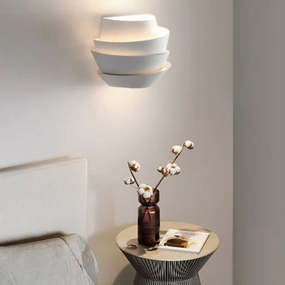 Residence Supply Rigno Wall Lamp showing sleek, modern design with a metal finish and mounted on a wall.