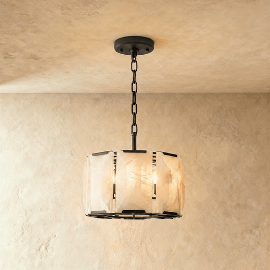 Round alabaster chandelier with intricate details, featuring a warm glow and elegant design by Residence Supply.
