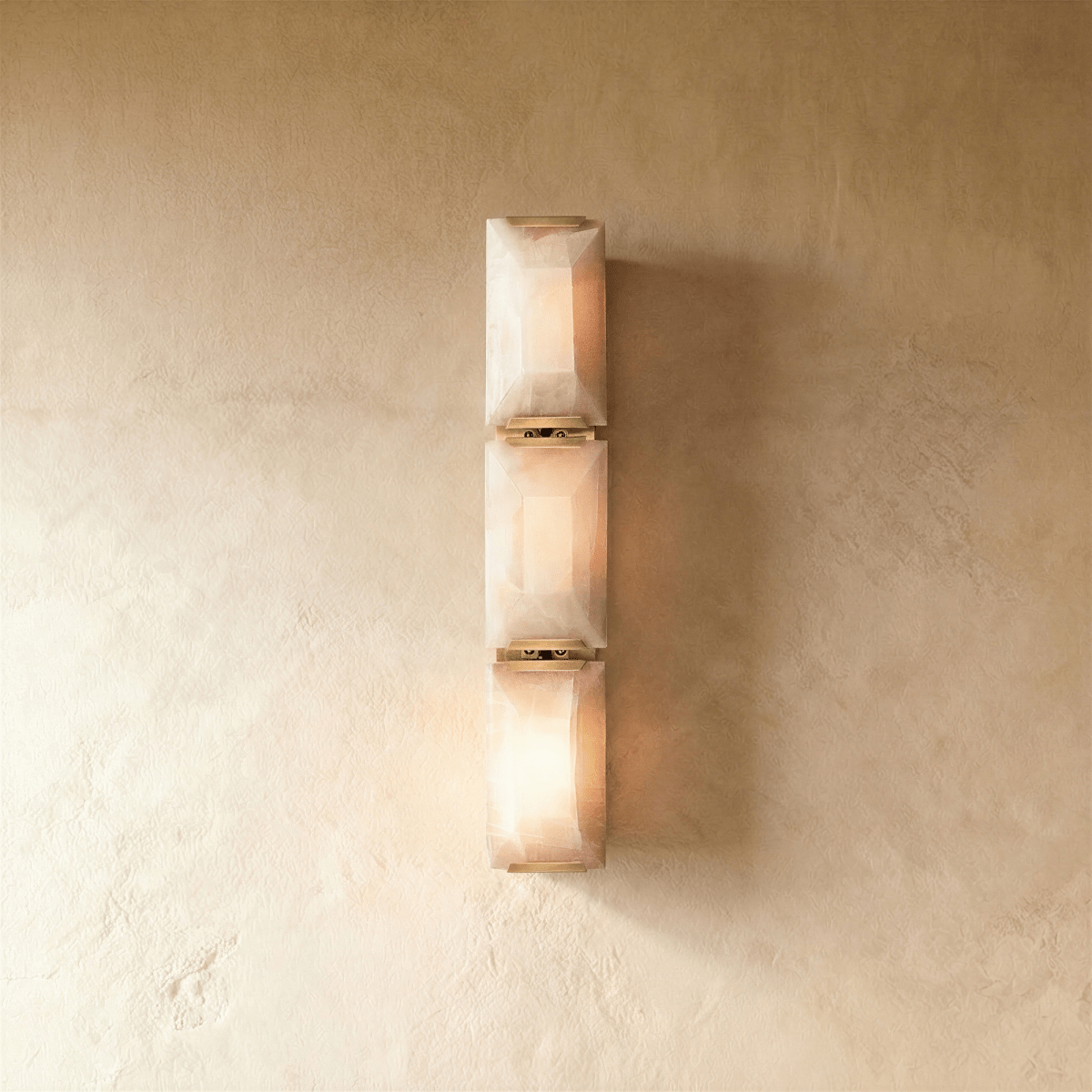 Sakhra wall lamp by Residence Supply featuring a textured, rustic design with a curved metal arm and a warm light fixture.