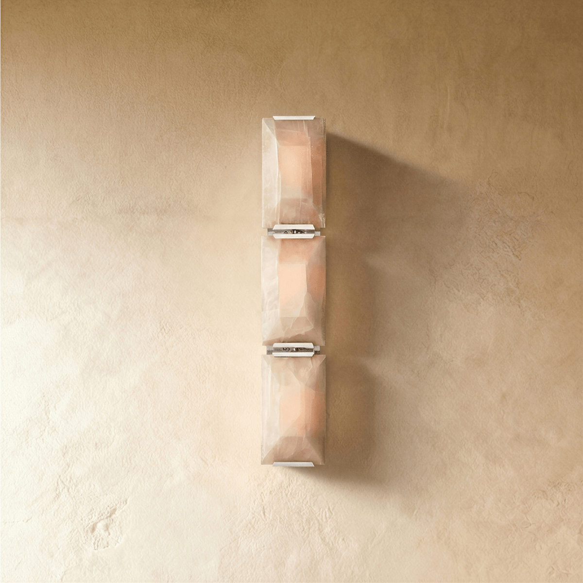 Residence Supply Sakhra Wall Lamp with intricate metal design and warm lighting, mounted on a wall for decorative illumination.