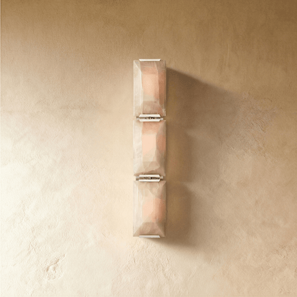Residence Supply Sakhra Wall Lamp with intricate metal design and warm lighting, mounted on a wall for decorative illumination.