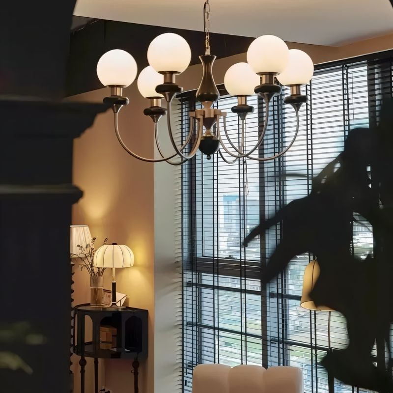 Elegant Scyre chandelier from Residence Supply with intricate metalwork and multiple light fixtures hanging from a decorative frame.