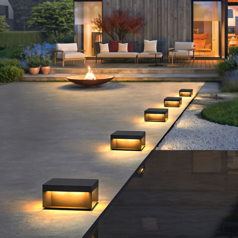 Senadina outdoor garden lamp by Residence Supply with sleek black metal design and warm illumination for outdoor spaces.