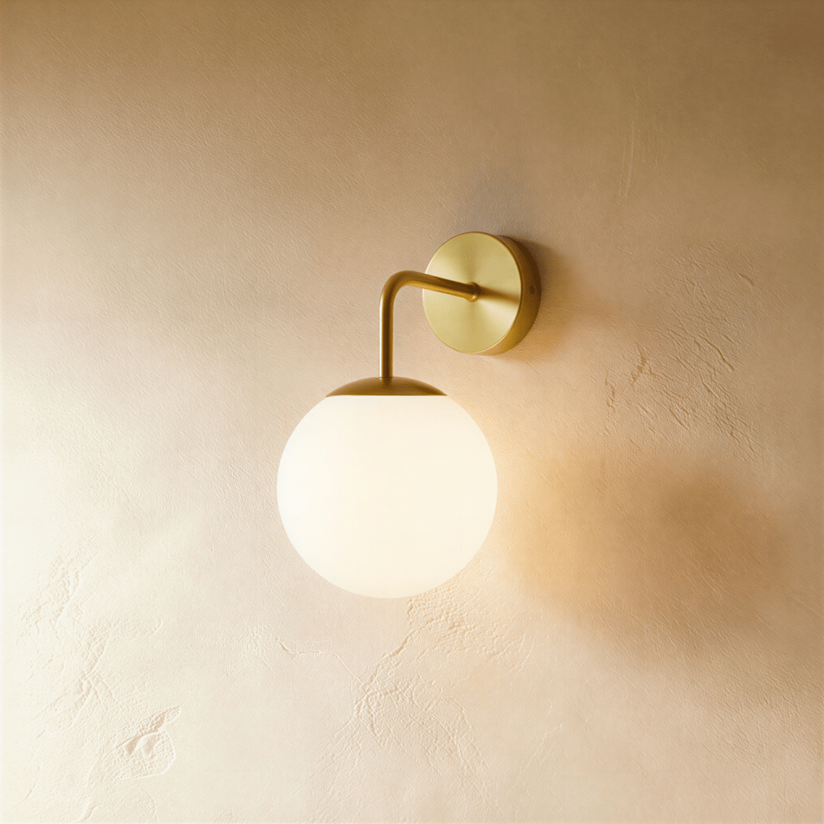 Modern Sfera Wall Lamp by Residence Supply featuring a sleek, spherical design with a warm light fixture.