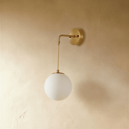 Modern Sfera Wall Lamp by Residence Supply with spherical glass shade and sleek metal arm, perfect for contemporary interior lighting.