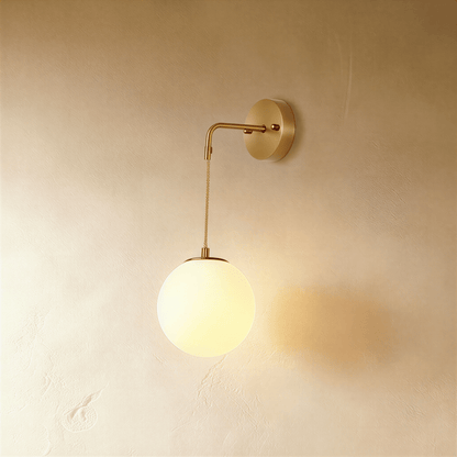 Sfera wall lamp by Residence Supply featuring a modern spherical design with a sleek metal finish and mounted on a wall.