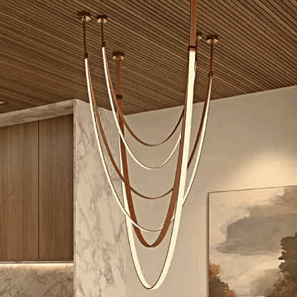 Leather chandelier with intricate detailing, featuring a warm, elegant design perfect for sophisticated interior decor.