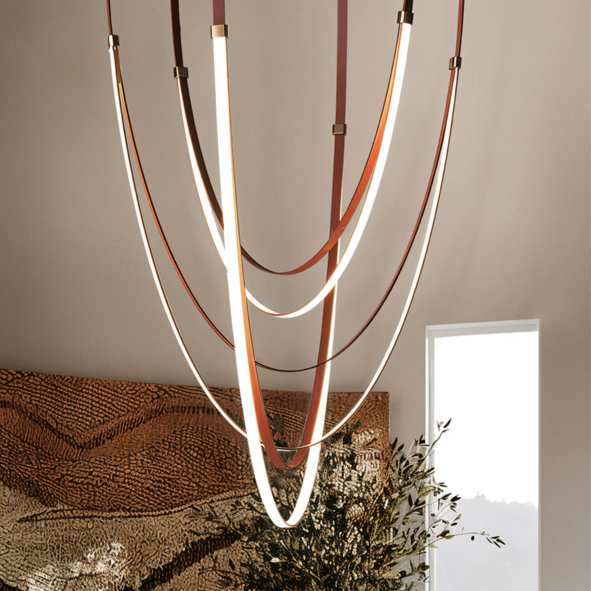 Leather chandelier with multiple hanging leather strips in warm tones, designed by Residence Supply for stylish interior lighting.