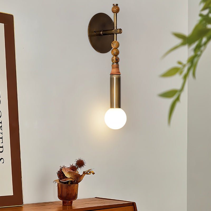 Residence Supply Shalti Wall Lamp with a sleek design, featuring a modern metal finish and warm interior lighting.