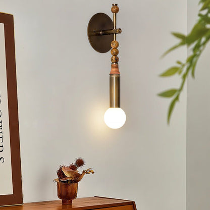 Residence Supply Shalti Wall Lamp with a sleek design, featuring a modern metal finish and warm interior lighting.