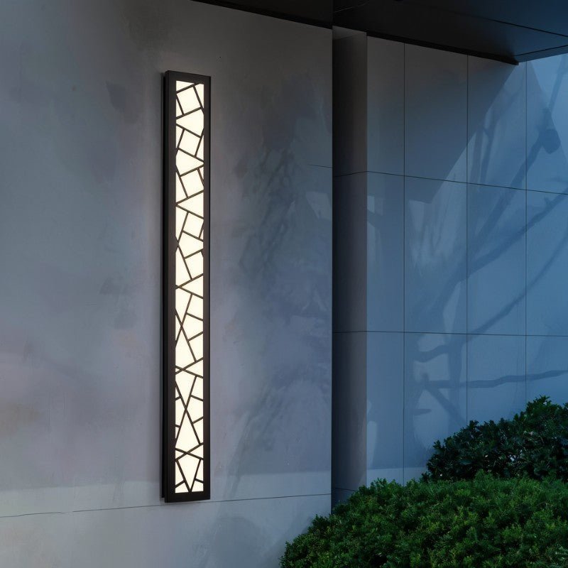 Shamil Wall Lamp by Residence Supply featuring a sleek modern design with a curved metal arm and a glass shade for ambient lighting.