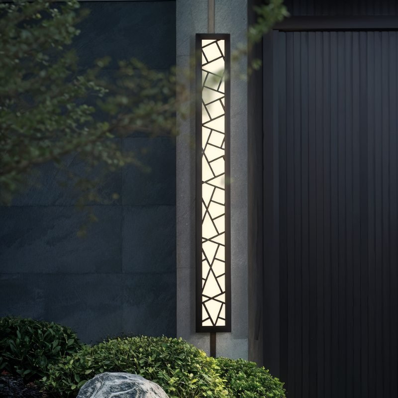 Shamil wall lamp by Residence Supply mounted on a wall, featuring a modern design with a sleek metal finish and ambient lighting.