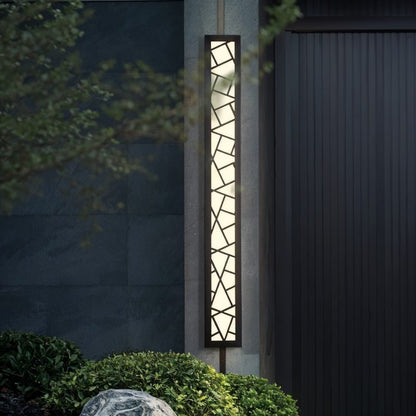 Shamil wall lamp by Residence Supply mounted on a wall, featuring a modern design with a sleek metal finish and ambient lighting.