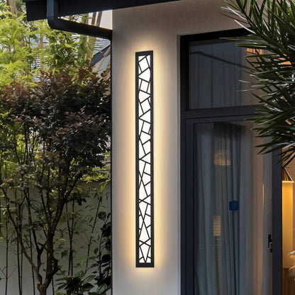 Shamil wall lamp by Residence Supply mounted on a wall with warm lighting and modern design details.