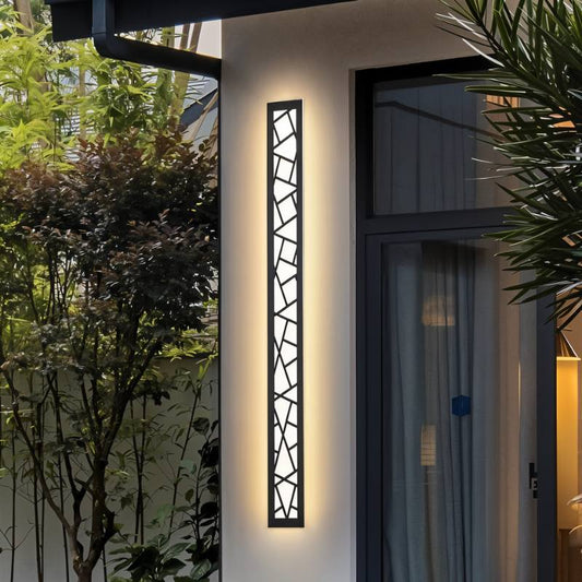 Shamil wall lamp by Residence Supply mounted on a wall with warm lighting and modern design details.