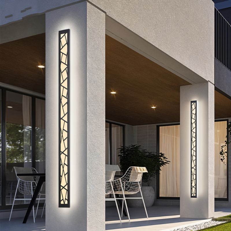 Shamil wall lamp from Residence Supply, modern fixture with a sleek design, mounted on a wall with warm ambient lighting.