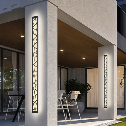 Shamil wall lamp from Residence Supply, modern fixture with a sleek design, mounted on a wall with warm ambient lighting.