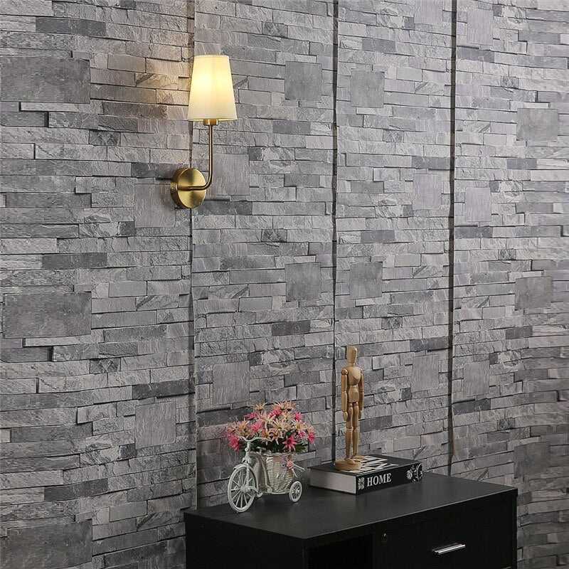Shira Wall Lamp by Residence Supply featuring a sleek, modern design with a curved metal arm and glass shade for stylish lighting.