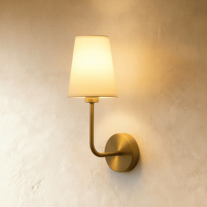 Shira Wall Lamp by Residence Supply featuring a modern design with a sleek metal finish and a mounted light fixture on the wall