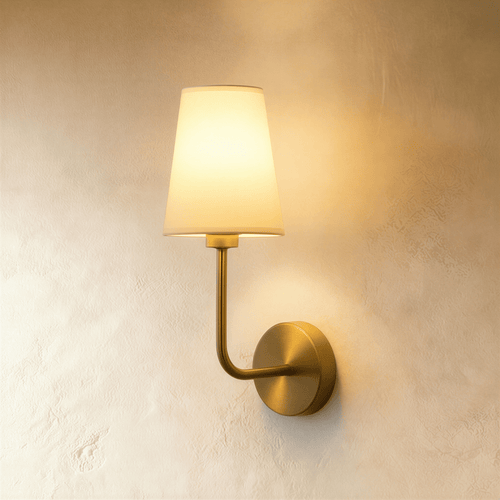 Shira Wall Lamp by Residence Supply featuring a modern design with a sleek metal finish and a mounted light fixture on the wall