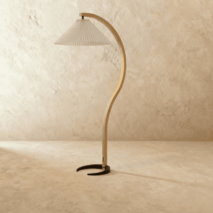 Skiastro Floor Lamp by Residence Supply featuring a modern, sleek design with a tall, curved metal stand and fabric shade.