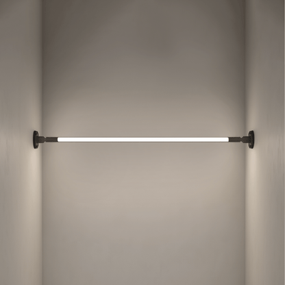 Residence Supply Skyline Wall Lamp mounted on a wall with a sleek, modern design and a warm lighting glow.