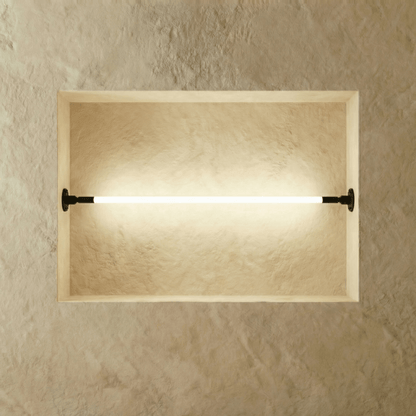 Residence Supply Skyline Wall Lamp showcasing a modern, sleek design with a curved metal arm and white shade for ambient lighting.
