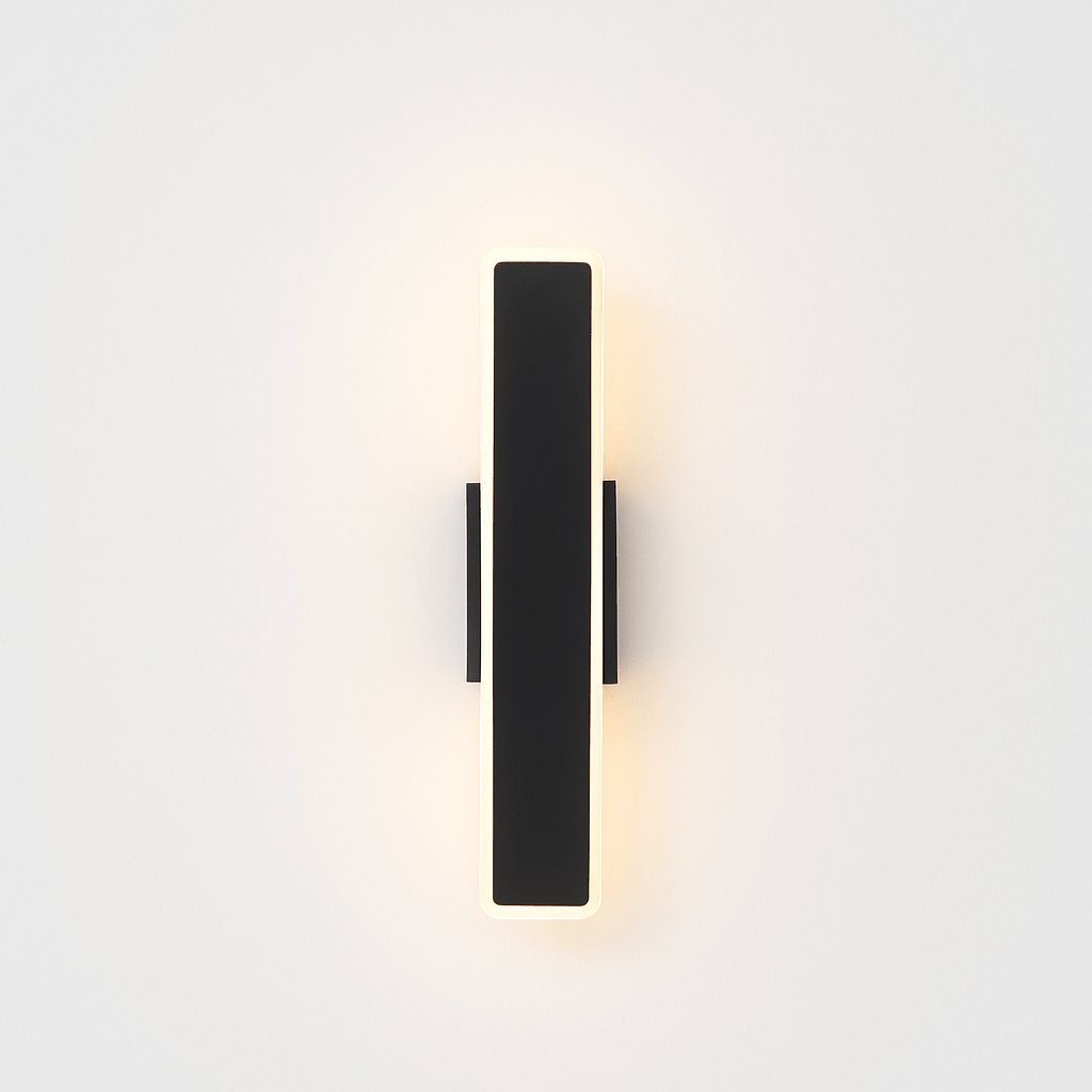 Modern slant wall lamp by Residence Supply with a sleek metal finish, mounted on a white wall for contemporary lighting.