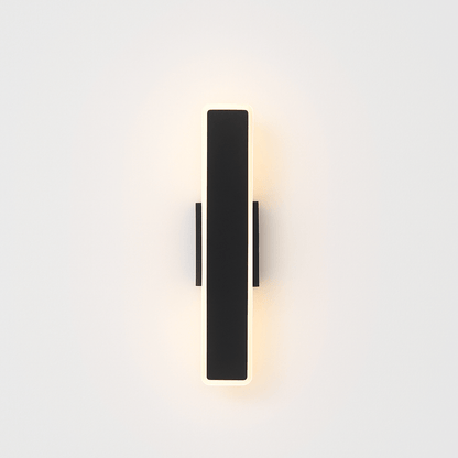 Modern slant wall lamp by Residence Supply with a sleek metal finish, mounted on a white wall for contemporary lighting.